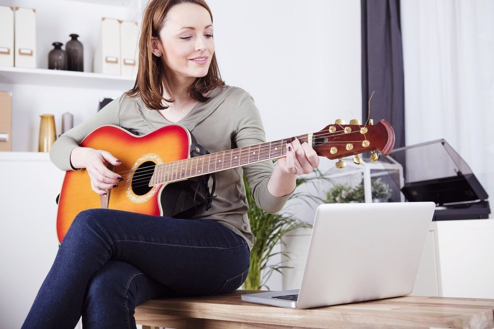 Woman learning guitar